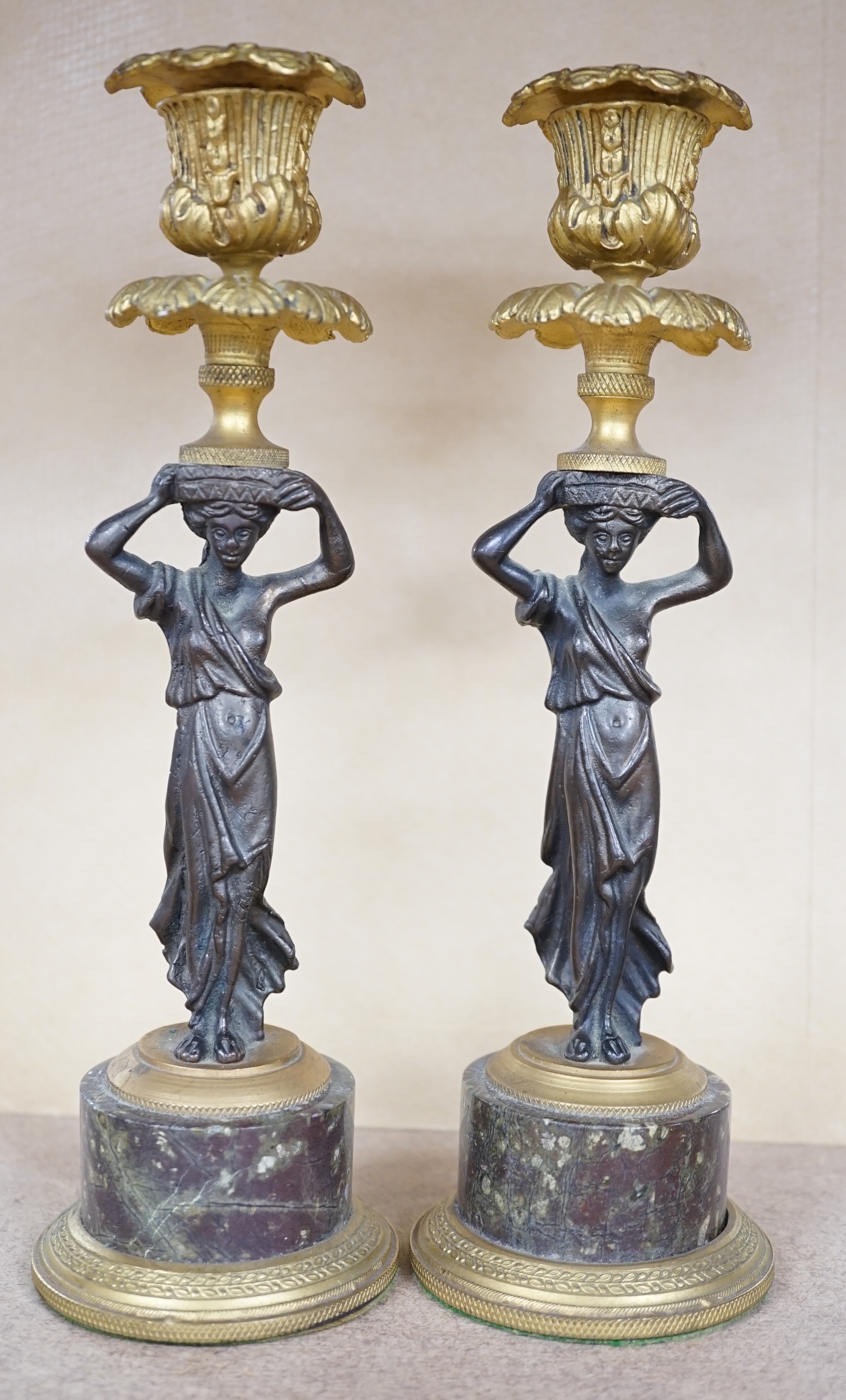 A pair of Regency style bronze and ormolu figural candlesticks on serpentine plinths, 22.5cm. Condition - fair to good